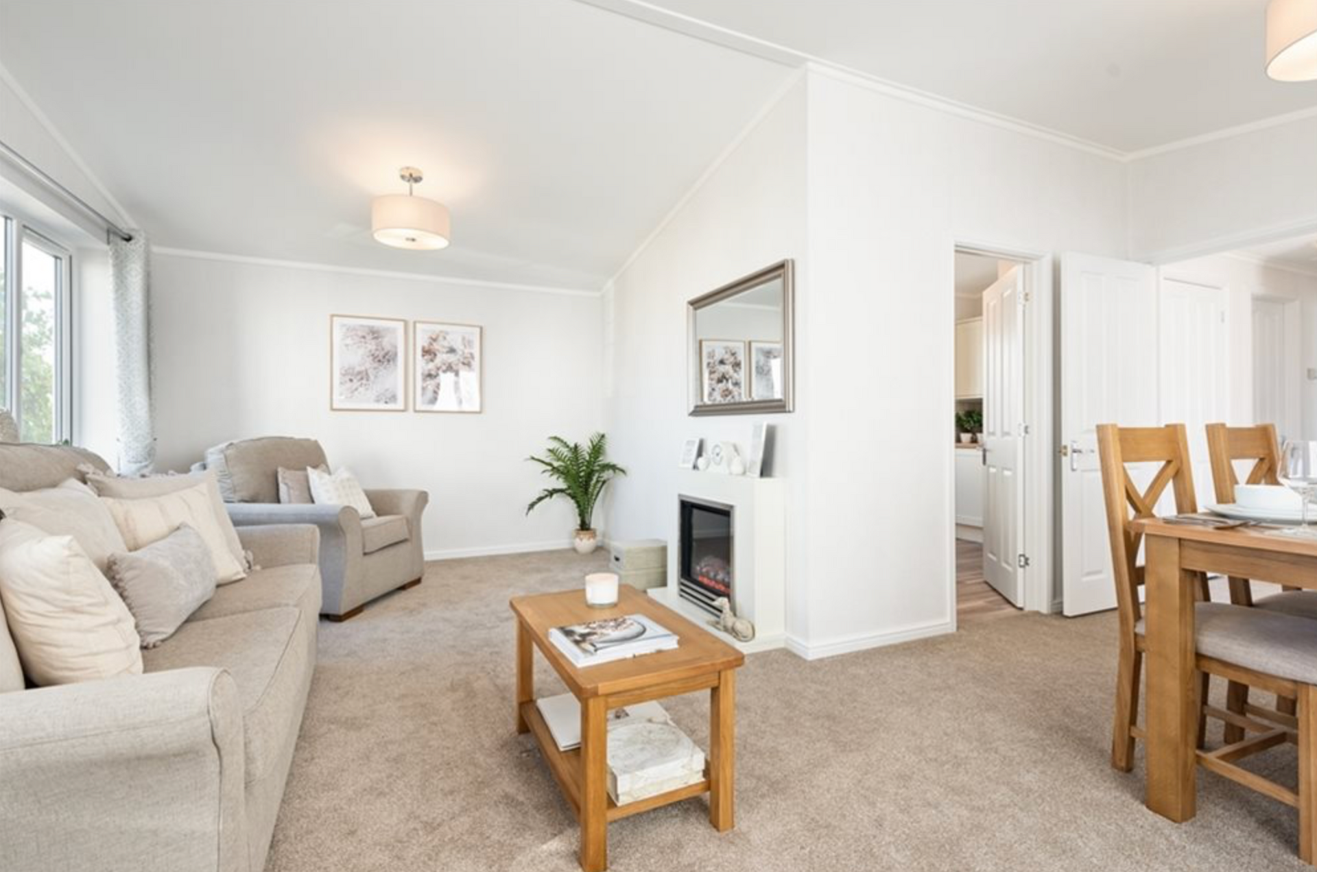 A large house with a lot of windows is sitting on top of a lush green field.