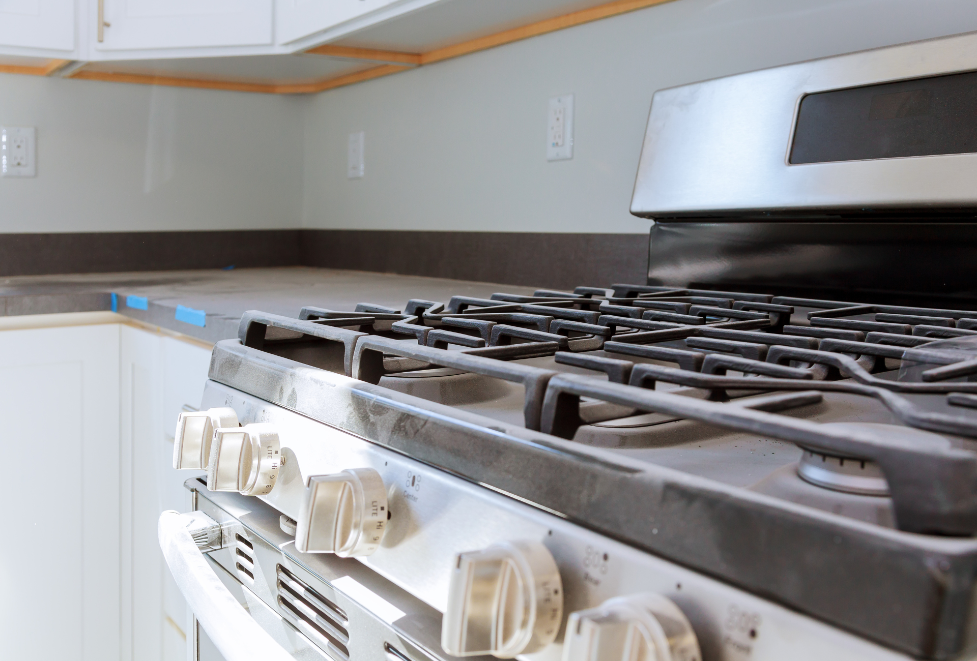 A stove top oven is sitting on top of a counter in a kitchen.