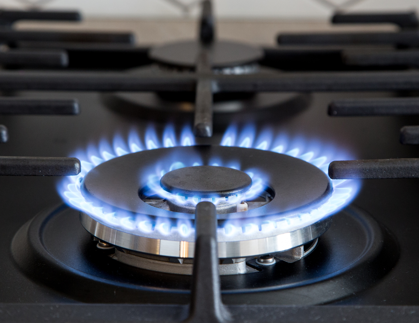 A close up of a gas stove with flames coming out of it