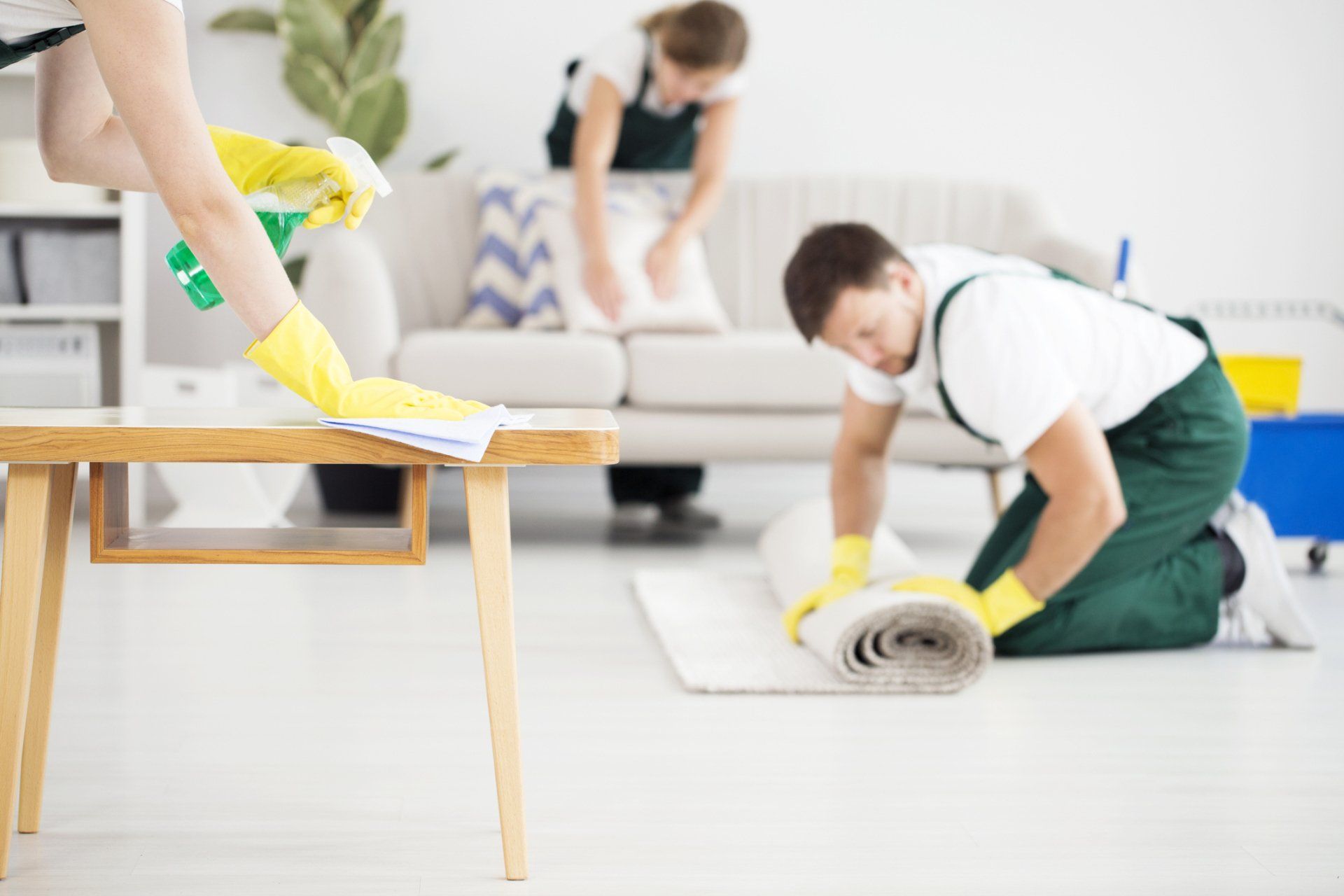 Group of Cleaners Rolling Carpet and Cleaning Furniture – Cheyenne, WY – Little Joe Company