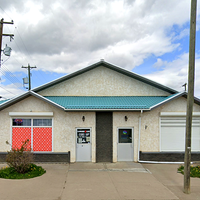 Jar of cannabis buds spilling onto a black surface.