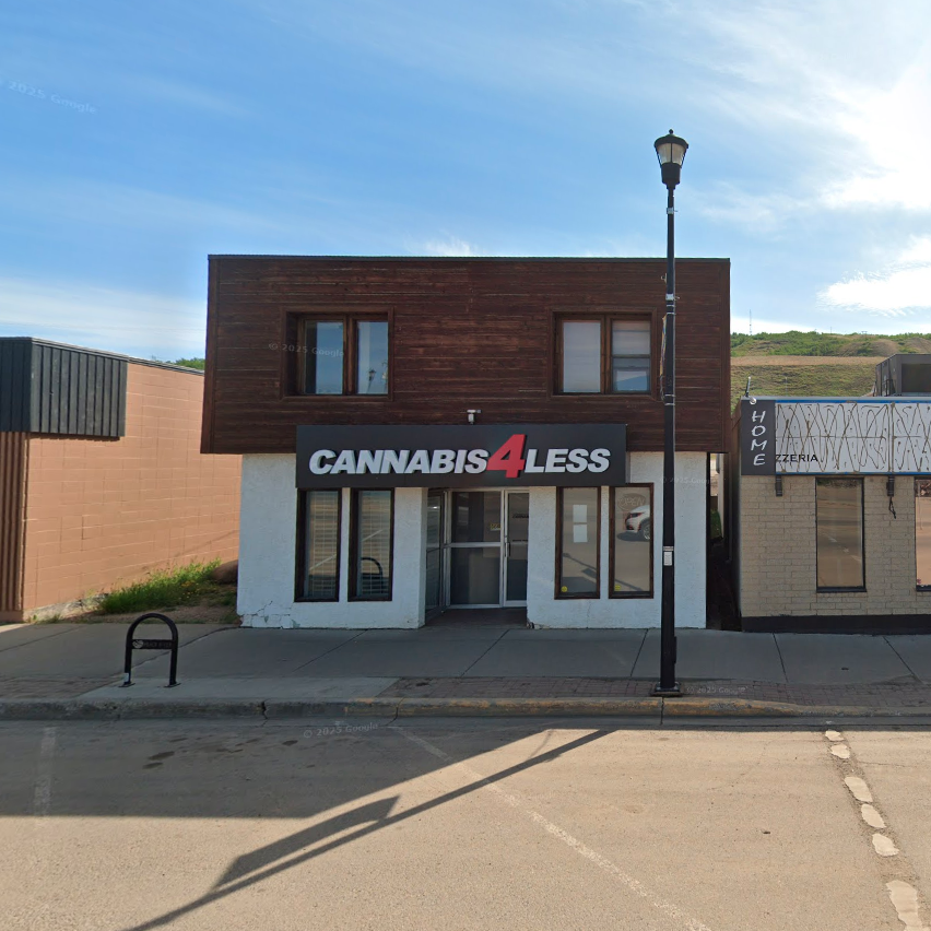 River flowing through a town, with a bridge. Hills and green vegetation surround it.