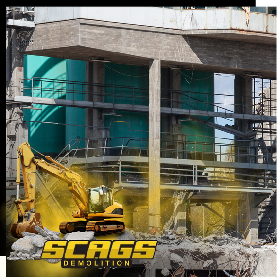 A demolished building with scags excavator