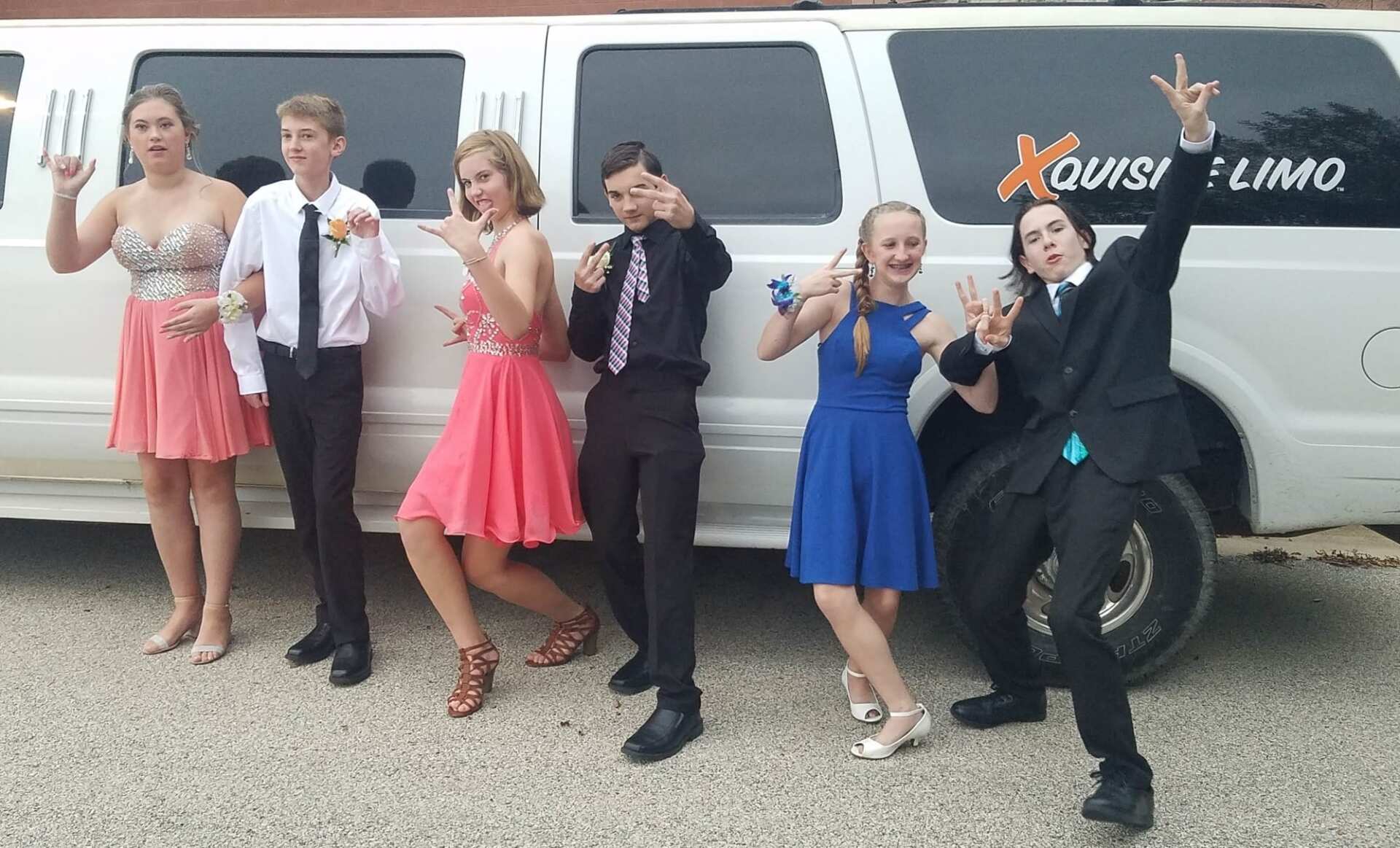 A group of people posing in front of an Iowa City limo. for Prom