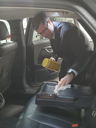 A driver with Xquisite Limo in Cedar Rapids, IA cleaning a car prior to a reservation.