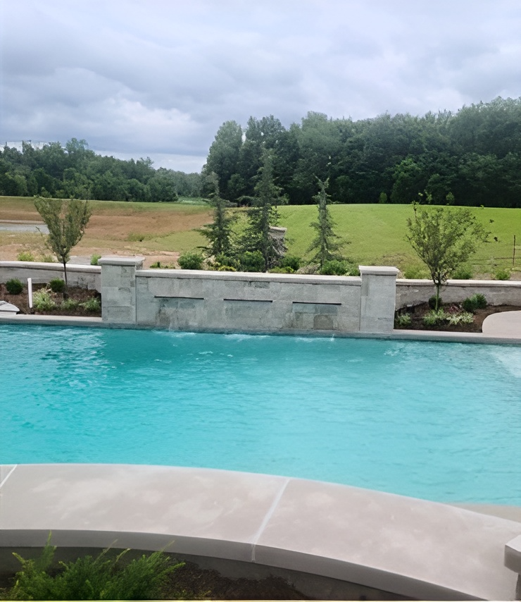 A large swimming pool with a waterfall in the background
