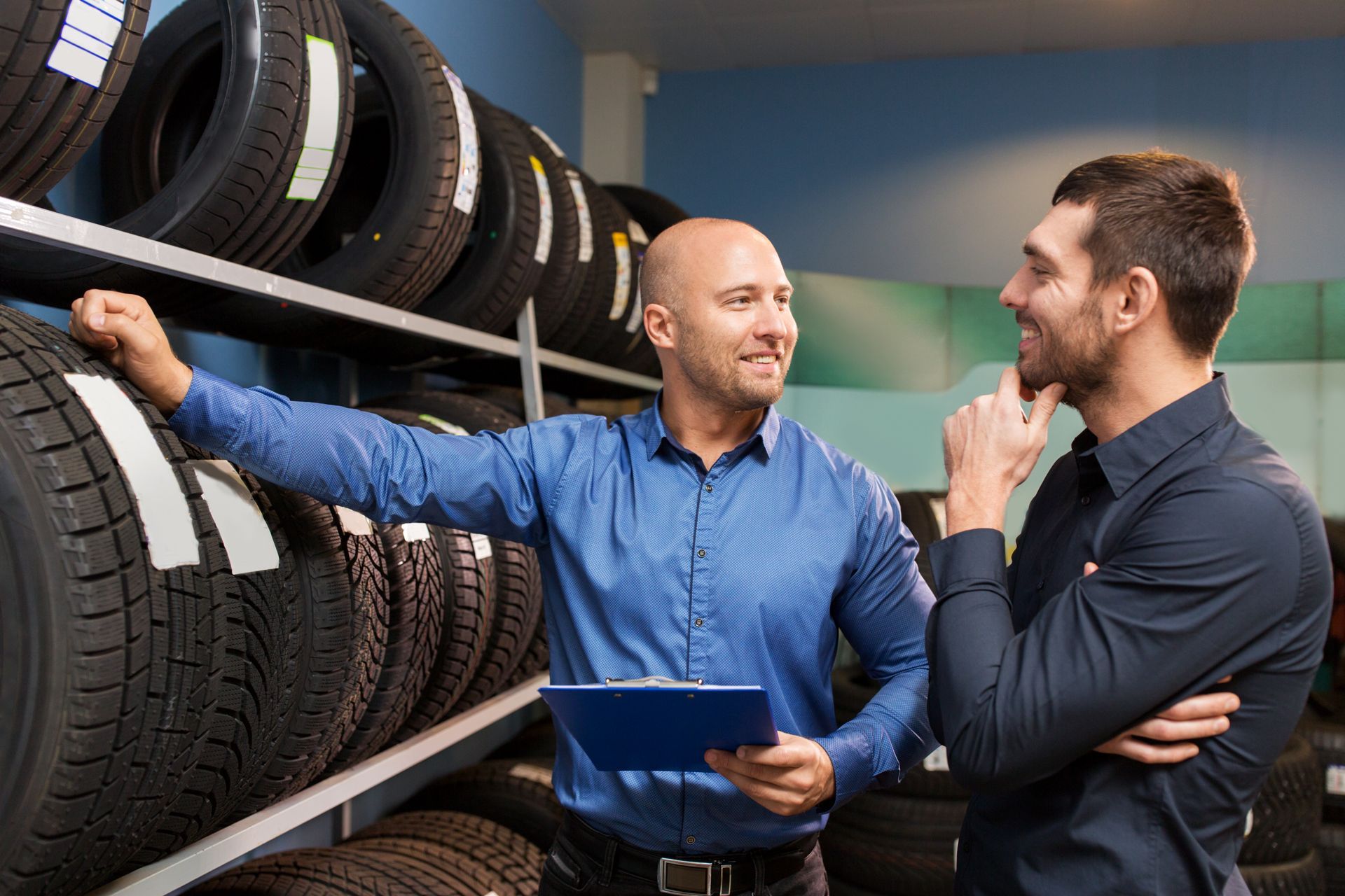 Customer and salesman at car service or tire shop. Customer and salesman at car service or tire shop.