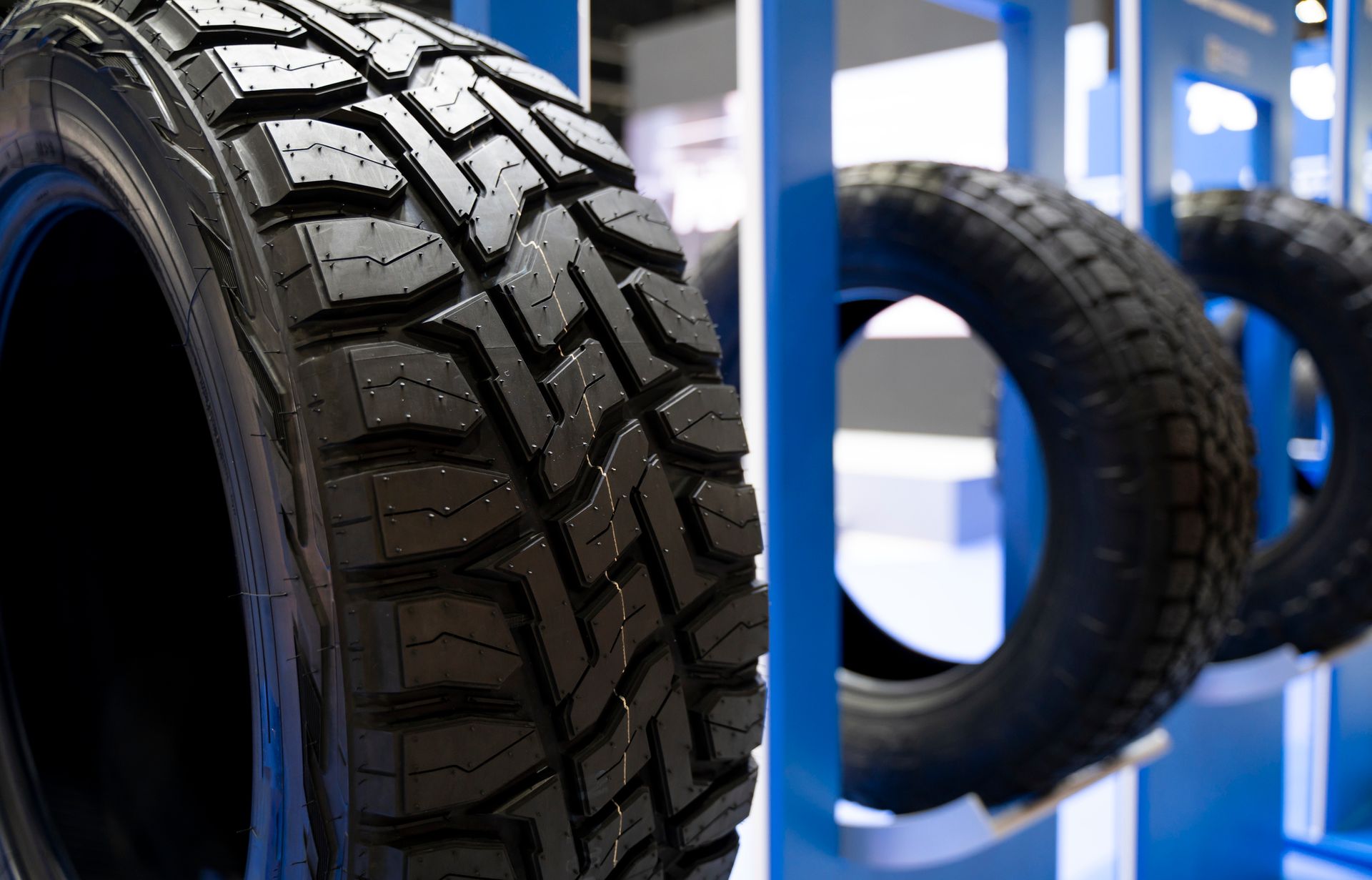 Close-up of a rugged tire with other tires in the background.