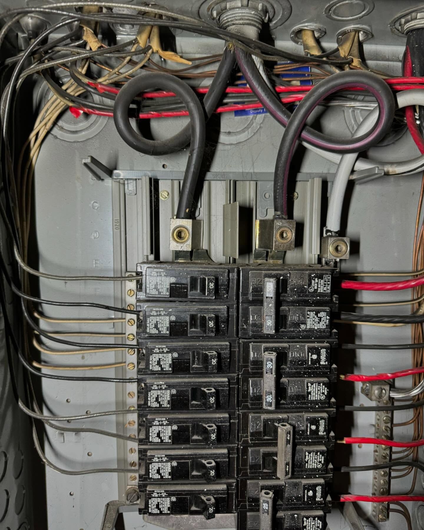 A close up of an electrical panel with a pair of scissors in it