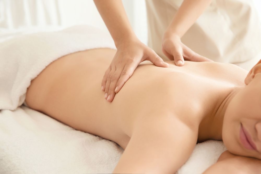 Person Receiving a Back Massage on a Massage Table — Innovated Wellness–Cathie Barnes in Yeppoon, QLD