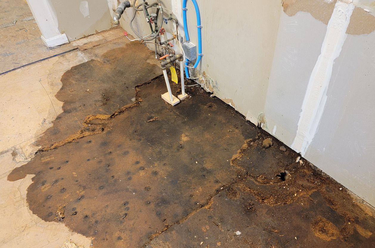 a basement floor with a lot of water coming out of it 