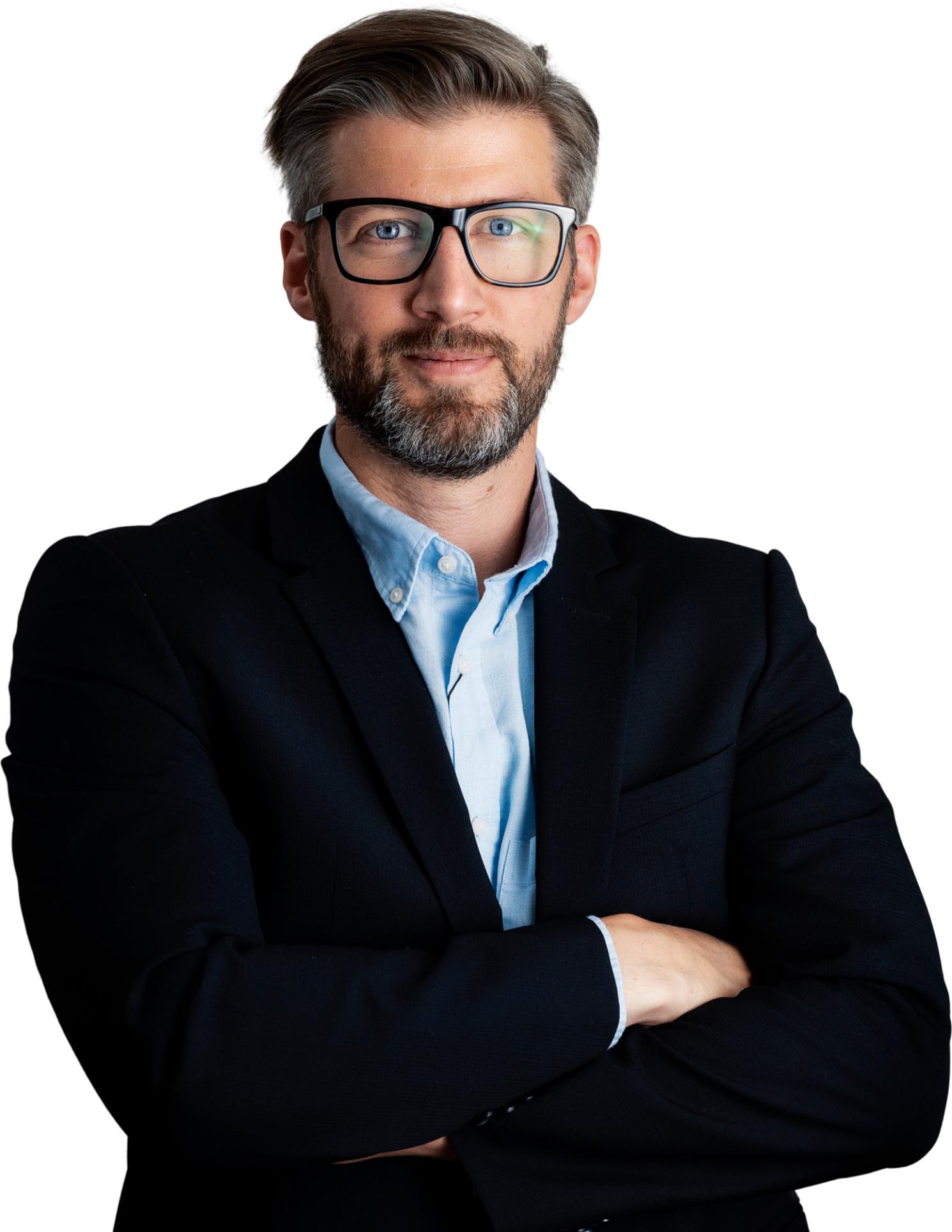 A man in a suit and glasses is standing with his arms crossed.