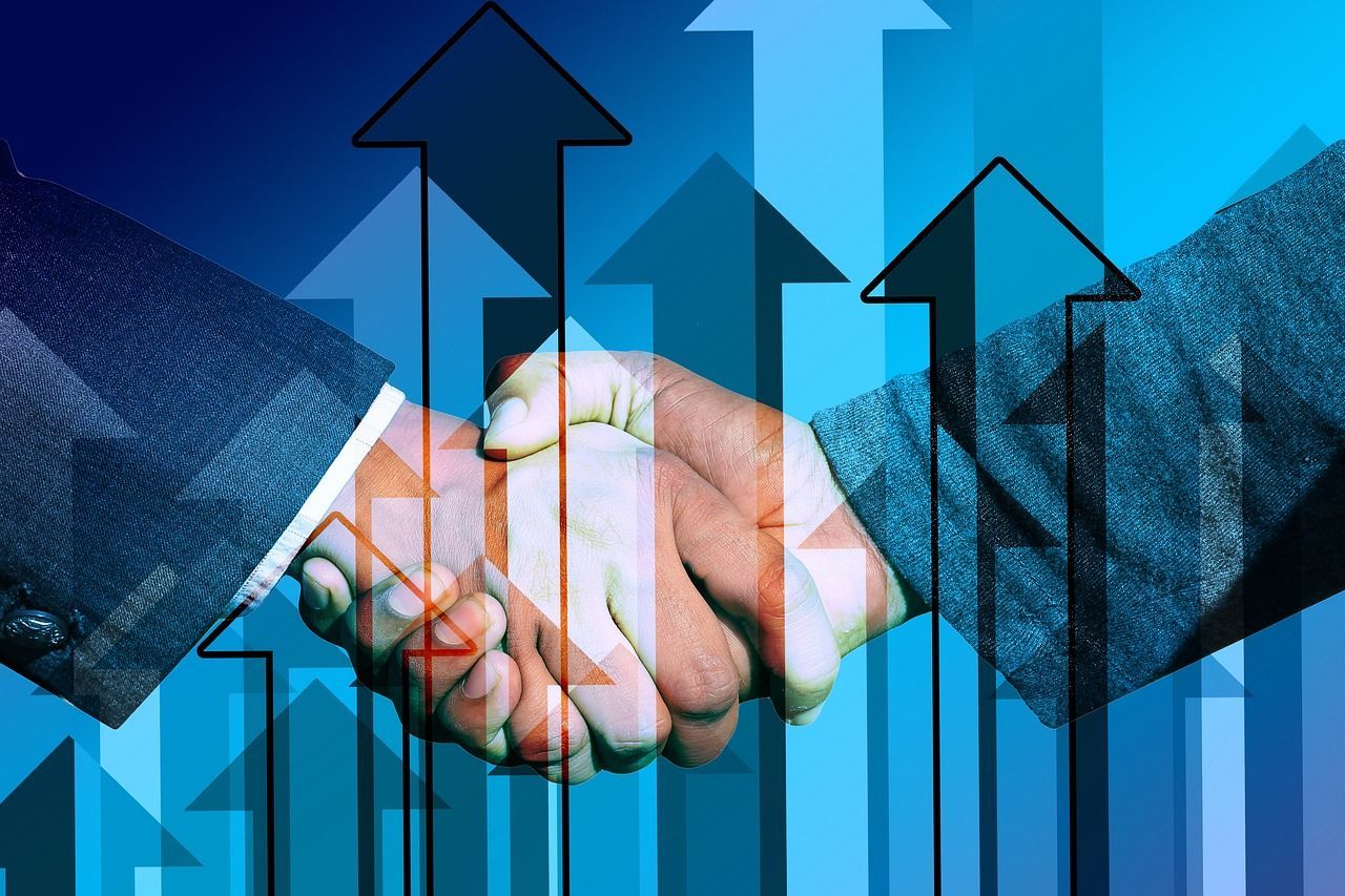 two men are shaking hands in front of a graph with arrows pointing up