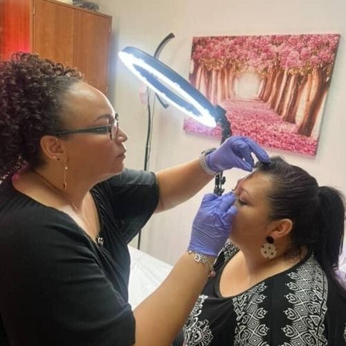 A woman is applying makeup to another woman 's face