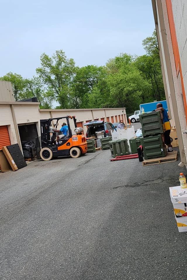 A forklift is driving down a street in a warehouse.