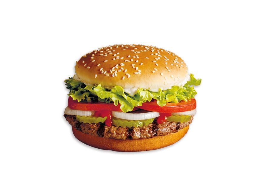 Burger on a sesame seed bun, with lettuce, tomato, pickles, and onion visible.