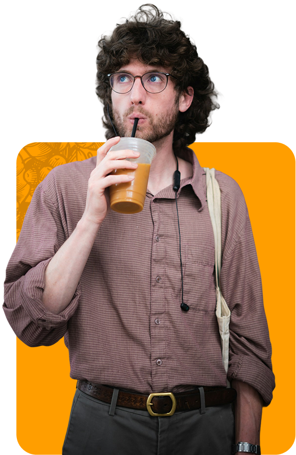 Man with curly hair sips iced coffee.