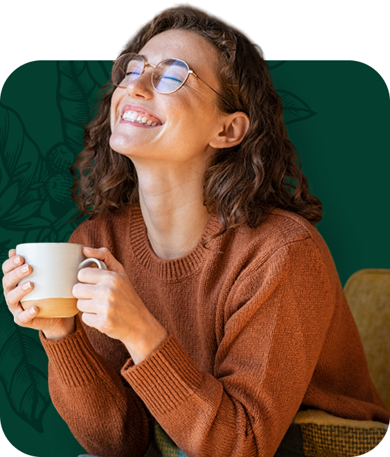 Man in black cap and shirt smiles, leaning on something, against a dark green background.