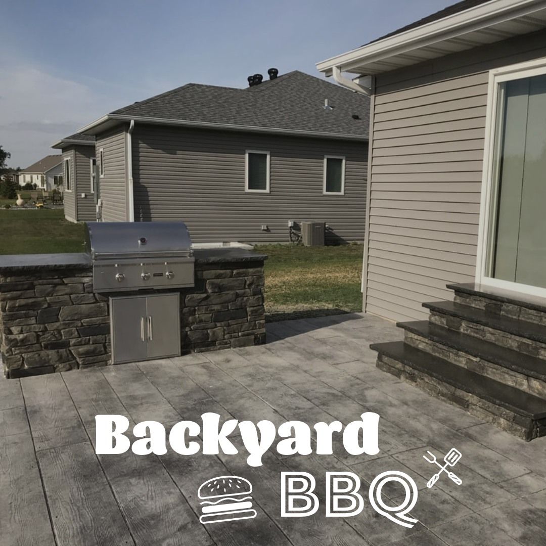 Outdoor backyard BBQ with grill and stonework, next to a home.