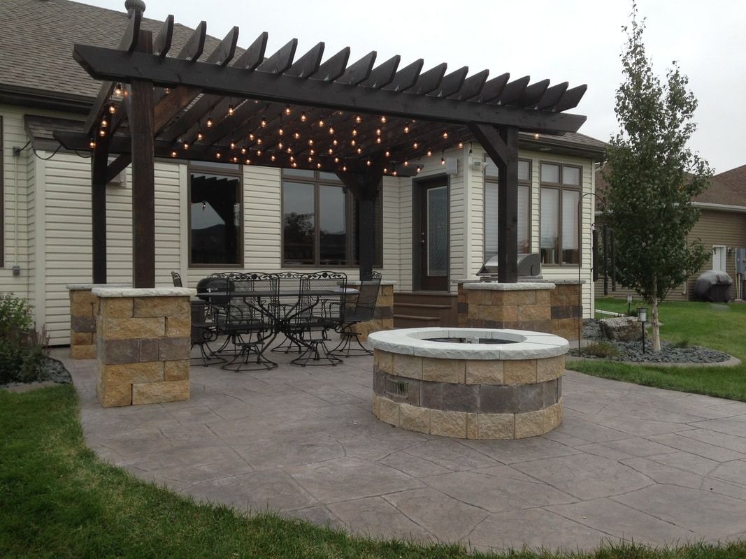 Patio with pergola, fire pit, and seating; exterior of a home.