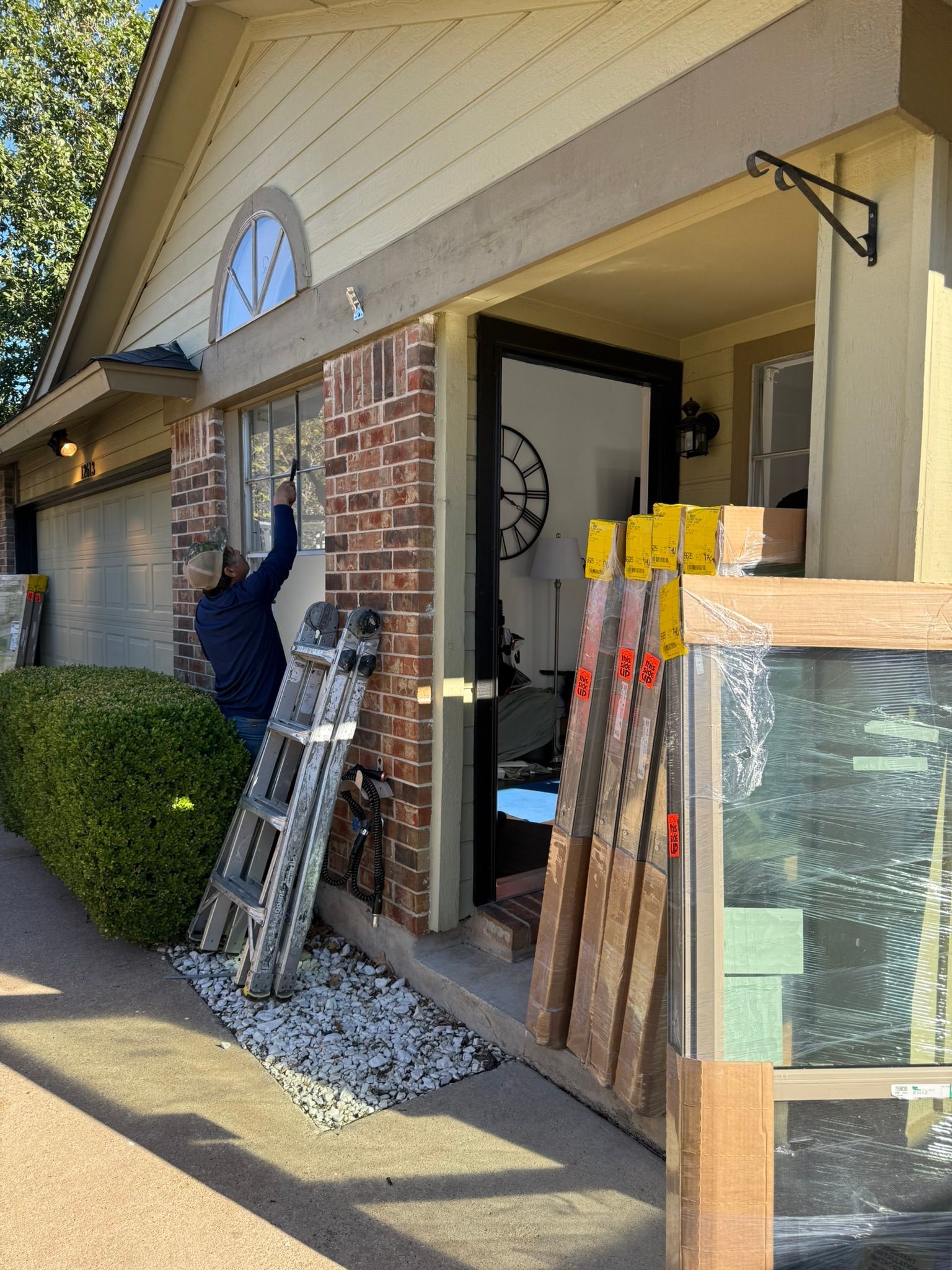 Two men are standing in an empty room with black walls