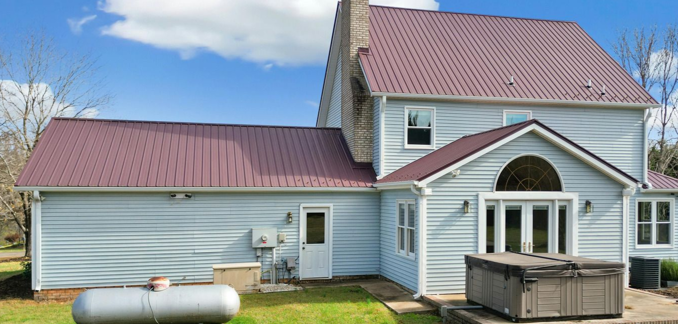 A man wearing a hard hat and goggles is standing in a room.