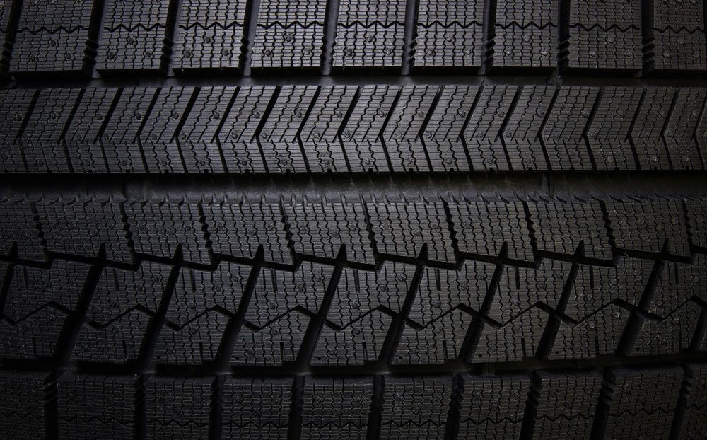 Red Car is Being Adjusted by a Machine — Capricorn Tyre & Mechanical in Yeppoon, QLD