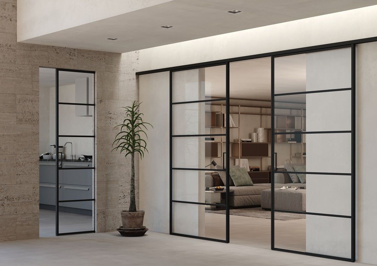 Un soggiorno con porte scorrevoli in vetro e una pianta in vaso.