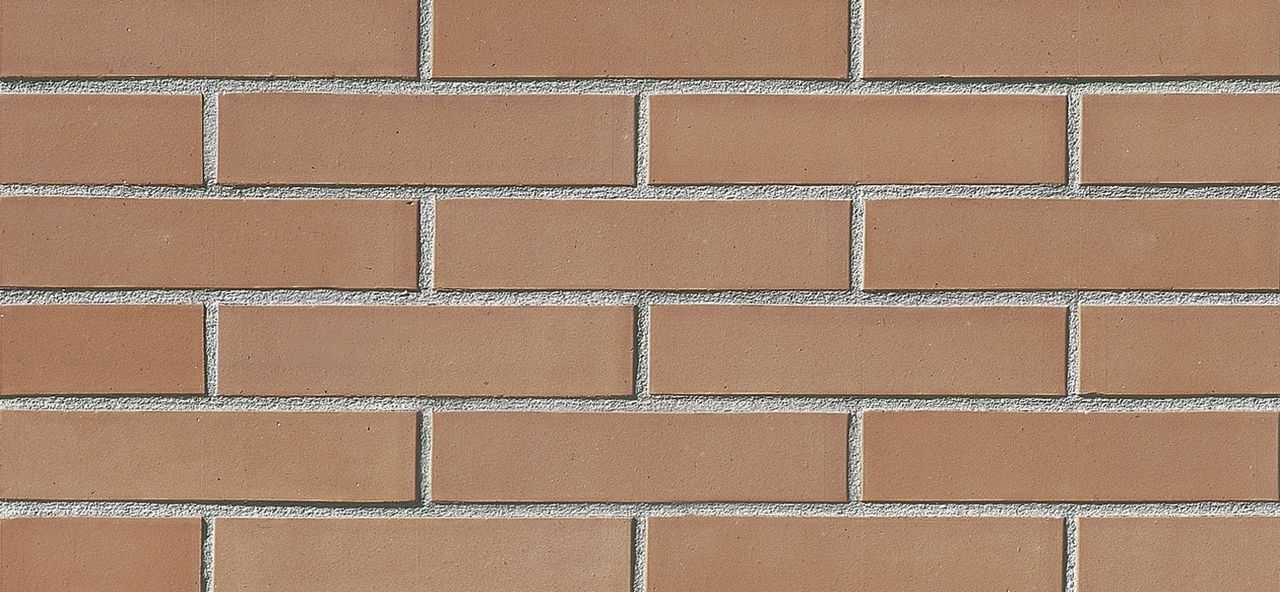 Un primo piano di un muro di mattoni con molti mattoni