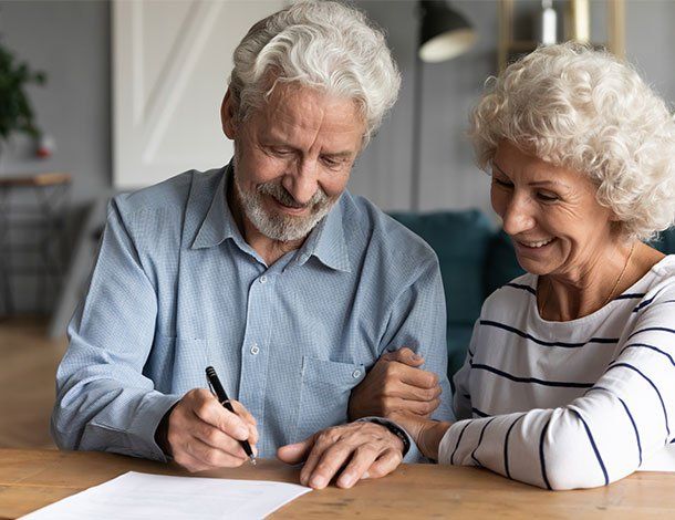 Old Couple Signing Papers — Springfield, MO — Dunn Law Firm LLC