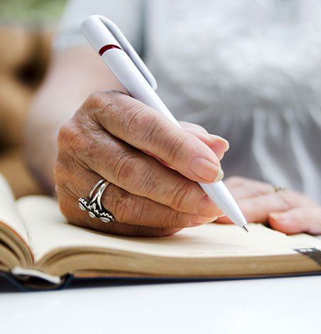 Woman Signing A Form — Springfield, MO — Dunn Law Firm LLC