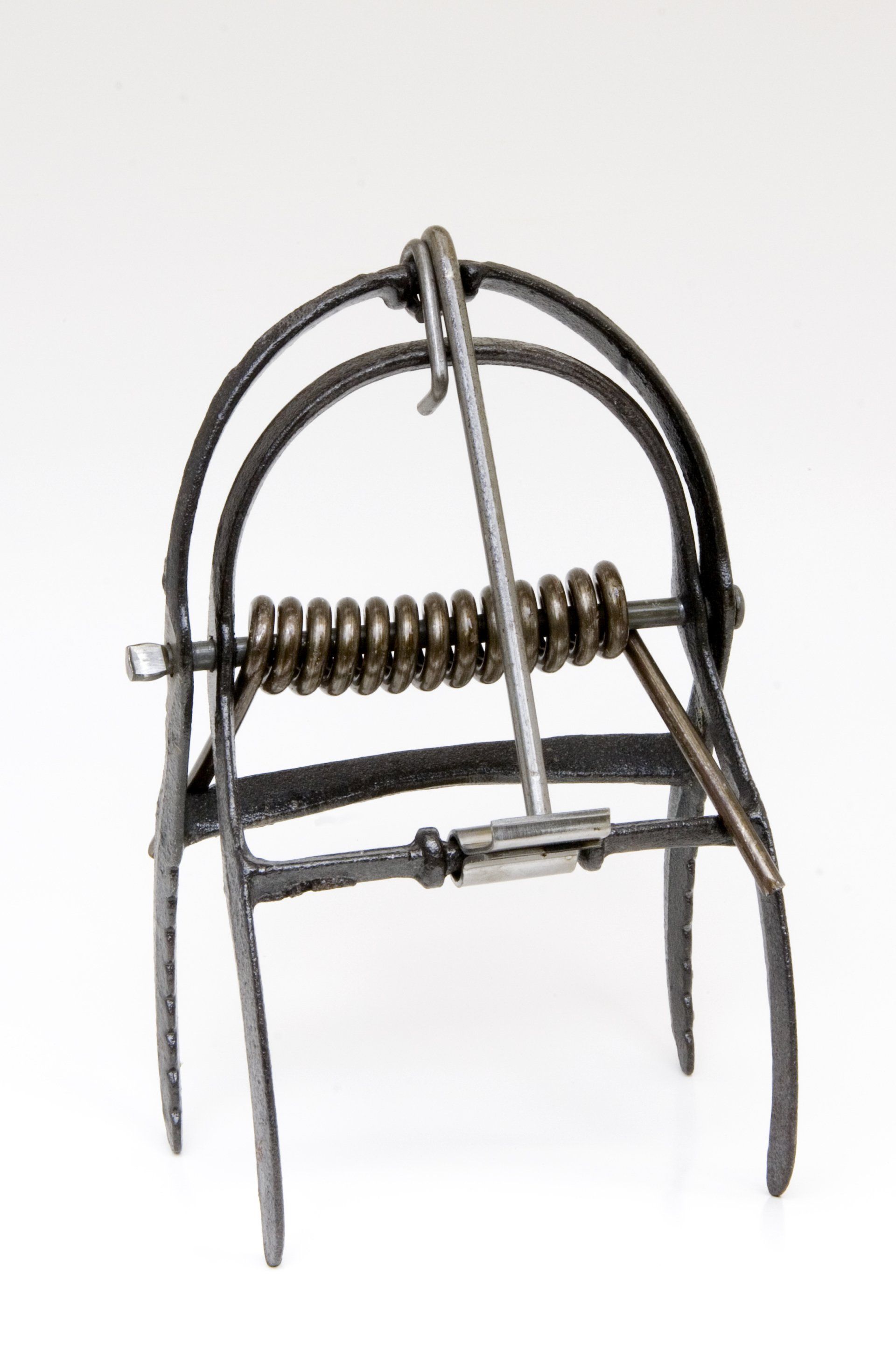 Steel animal trap with a spring mechanism, ready to be set.