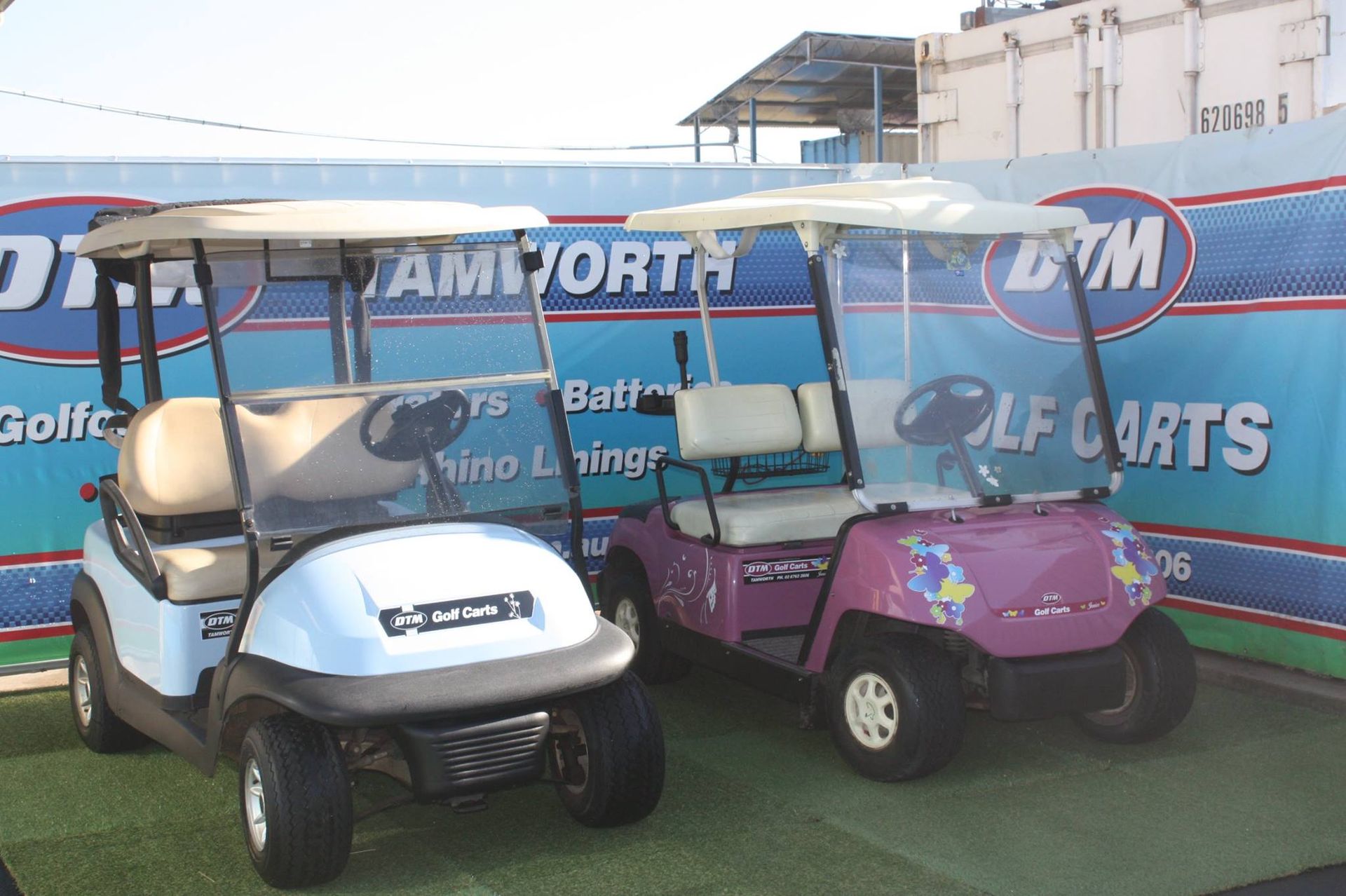 Two Golf Carts Parked on Artificial Grass at Golf Cart Shop — DTM Tamworth in Tamworth, NSW