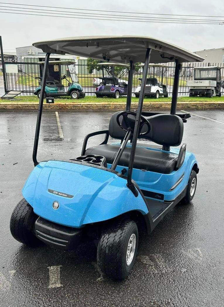 A Blue Golf Cart Is Parked in A Parking Lot — DTM Tamworth in Tamworth, NSW