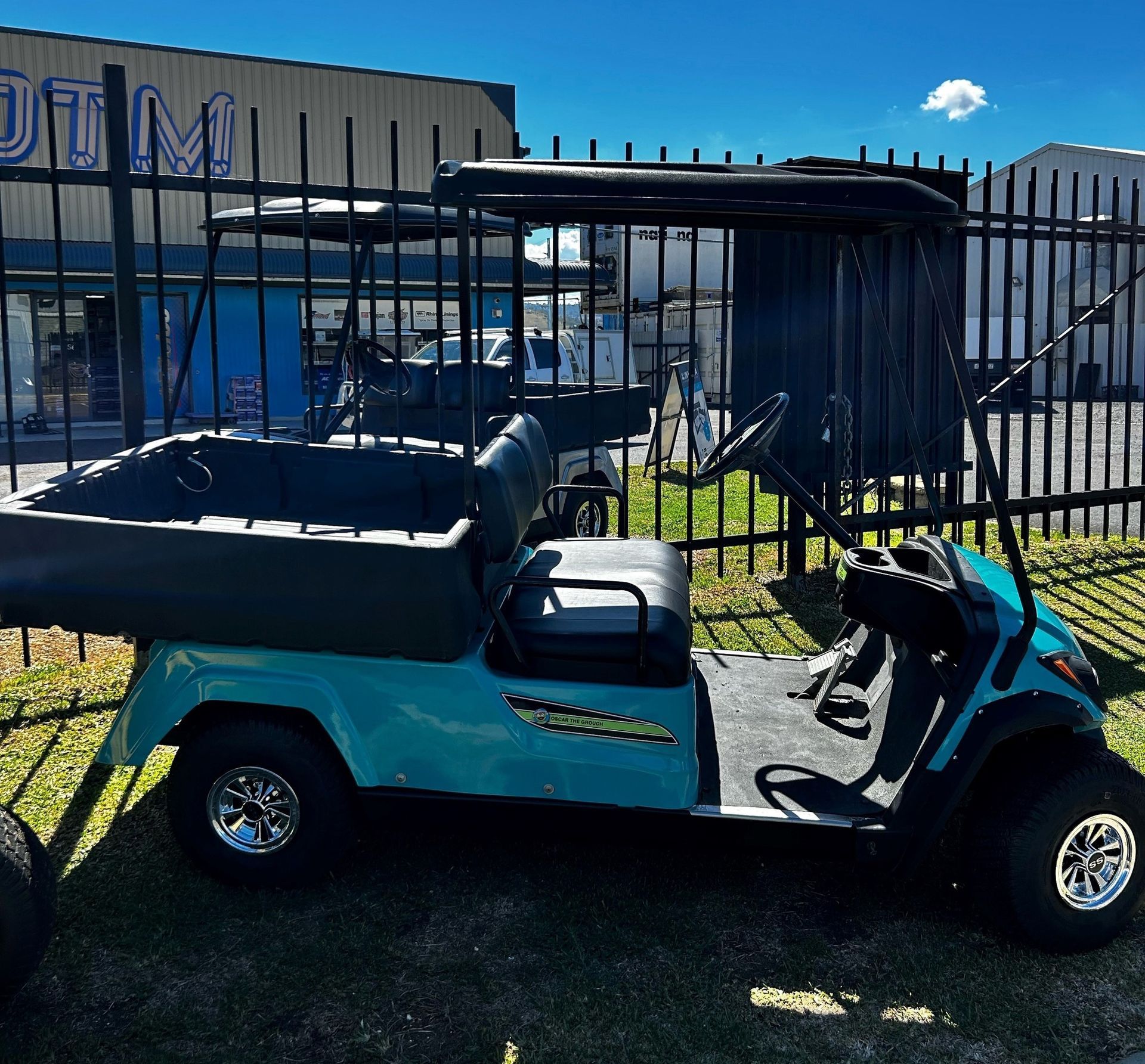 A Golf Cart with Seats and Tray  Is Parked in Front of A Building — DTM Tamworth in Tamworth, NSW