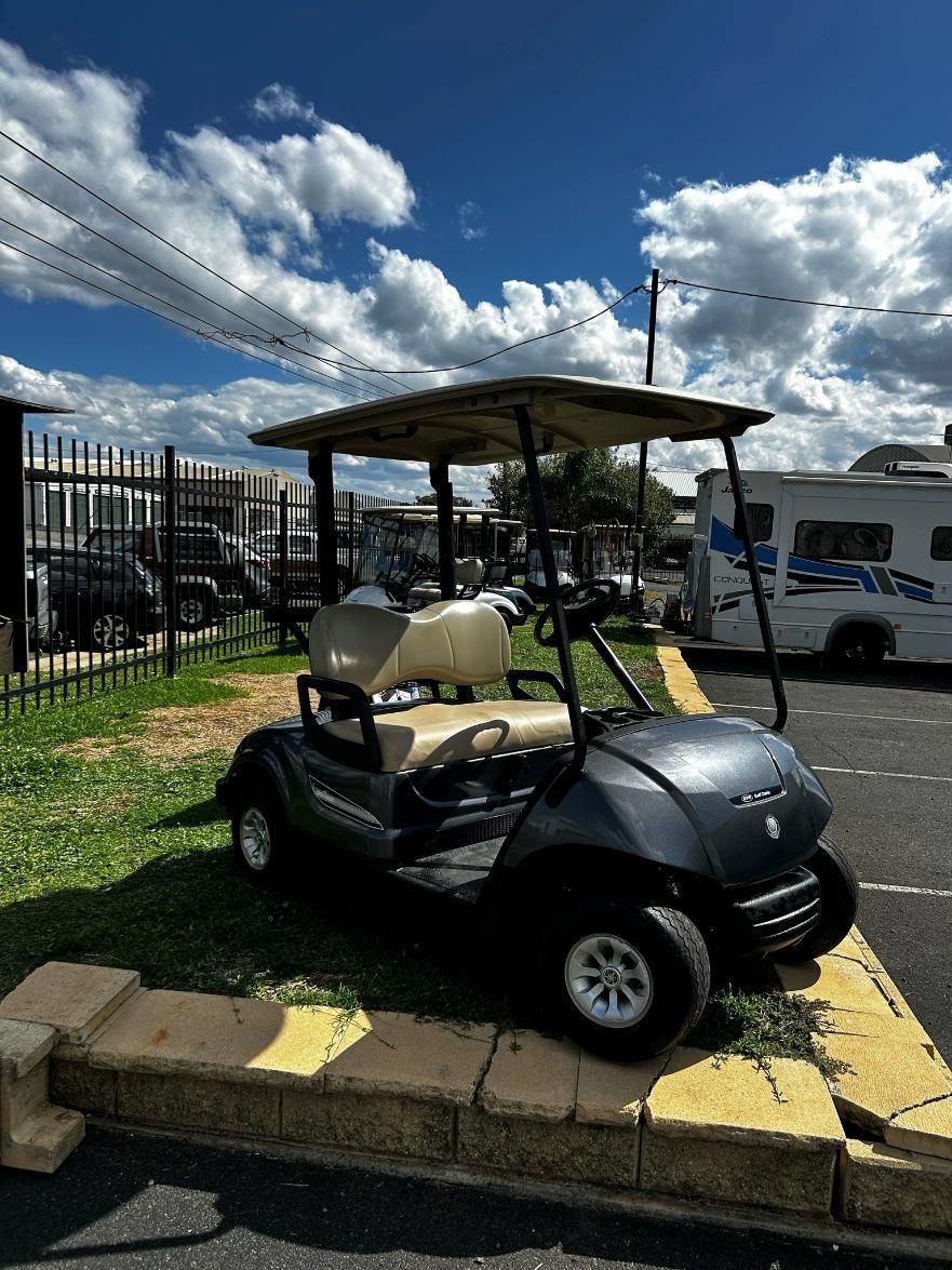 A Golf Cart Is Parked on The Side of The Road in A Parking Lot — DTM Tamworth in Tamworth, NSW