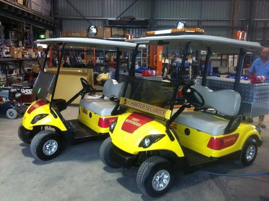Two Yellow Golf Carts Are Parked in A Warehouse — DTM Tamworth in Tamworth, NSW