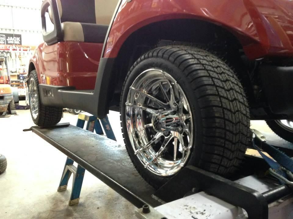A Red Golf Cart Is Sitting on A Ramp in A Garage — DTM Tamworth in Tamworth, NSW