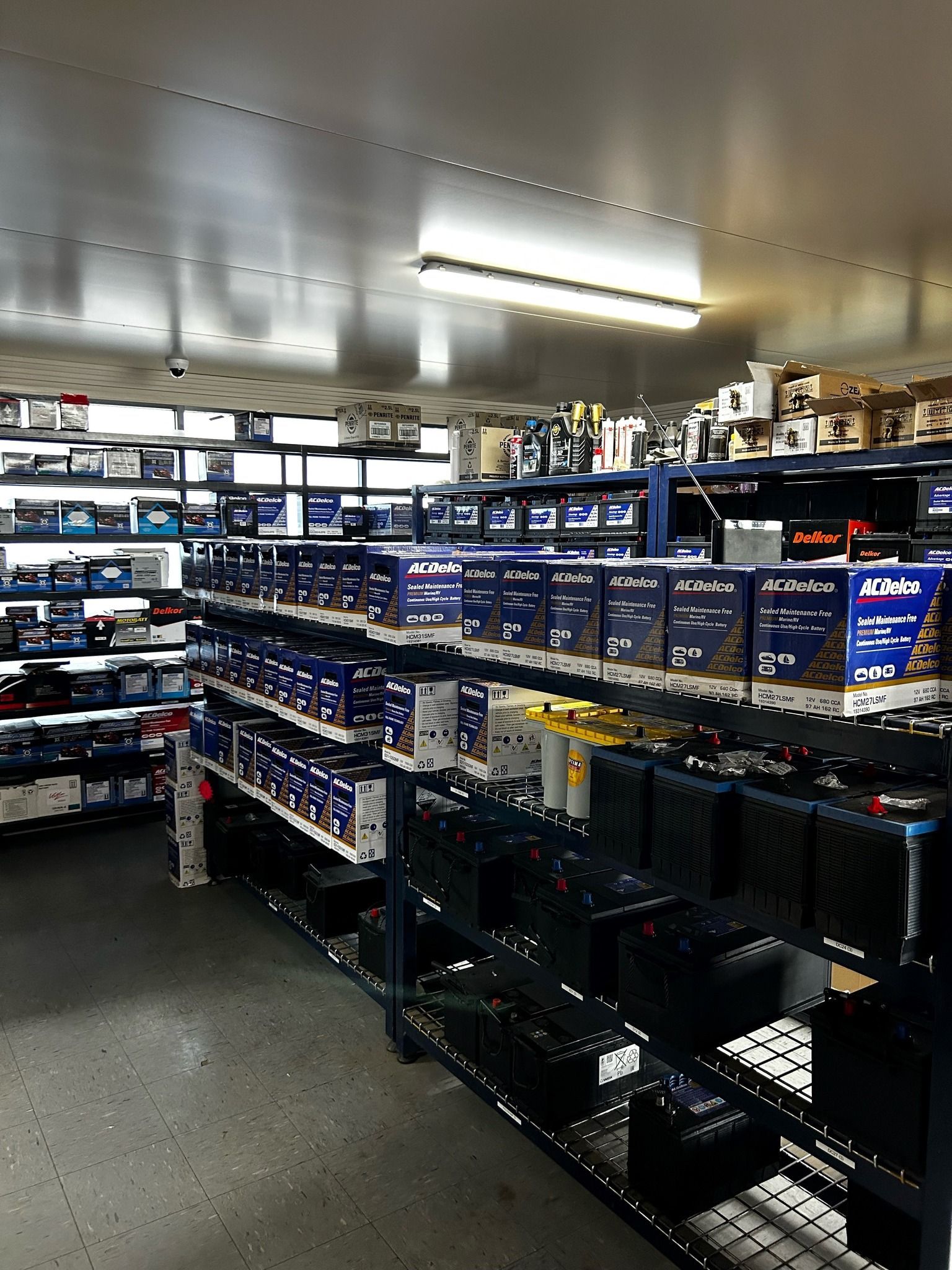 Store Shelves Displaying Cart Batteries And Automotive Products