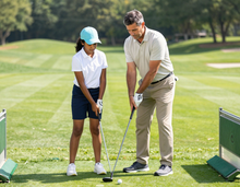 Golf coach demonstrating setup on the range