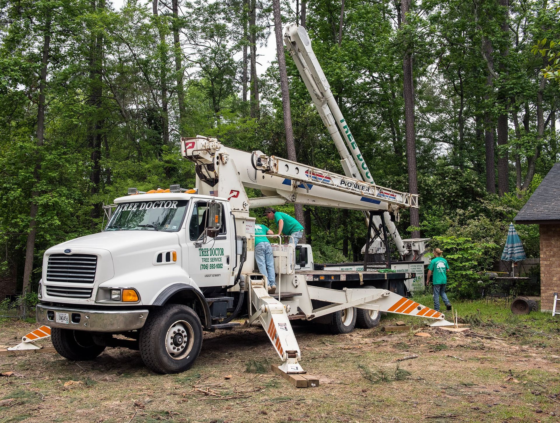 A white truck with a crane attached to it that says box jts