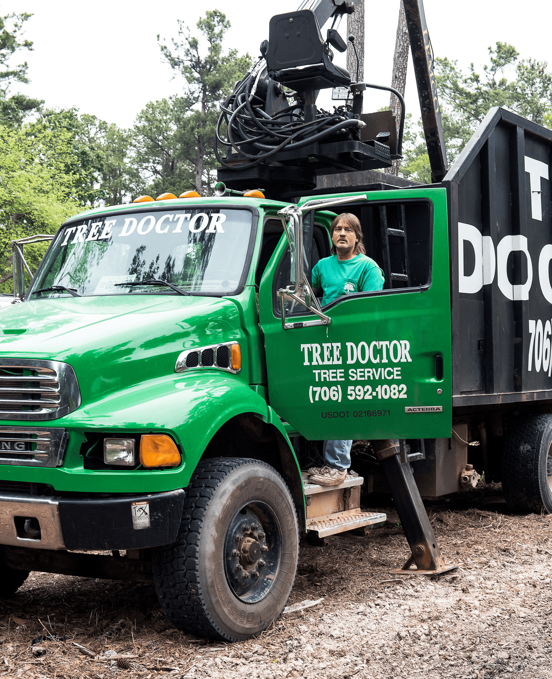 A green truck that says tree doctor on it