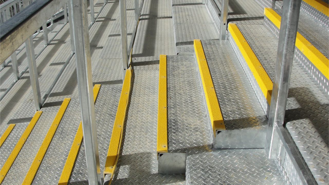 A close up of a set of stairs with yellow markings