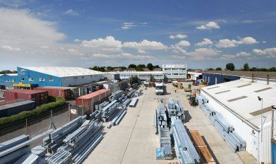 An aerial view of a warehouse filled with lots of metal pipes.