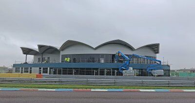 A large building is being built on a race track.