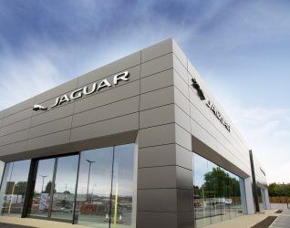 A large jaguar car dealership with a lot of windows