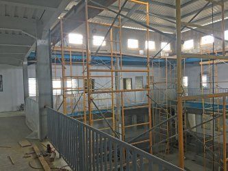 A  Reidsteel building under construction with scaffolding and stairs.