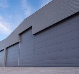 A large gray Reidsteel building with a lot of doors on it.