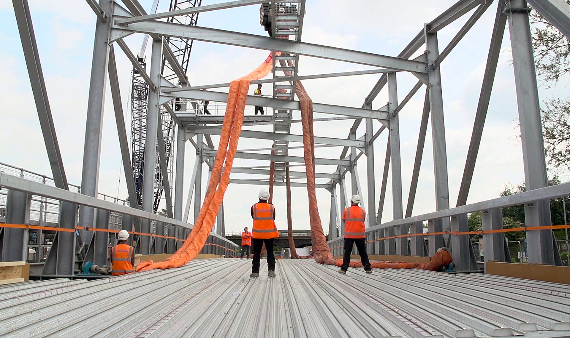 A group of construction workers are working on a bridge.