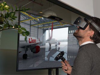 A man wearing a virtual reality headset is playing a video game.